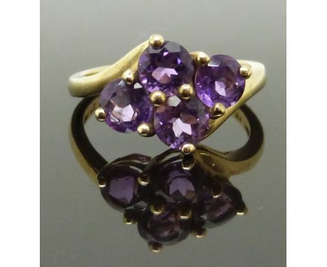 A 9ct gold ring set with four round cut amethysts, size K, 2.63g