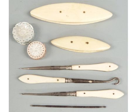 Sewing collectables to include two mother of pearl pin cushions, two ivory mounted winders and three manicure or similar tool