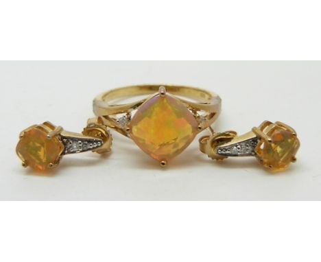 A 9ct gold ring set with a cushion cut Indonesian opal and diamonds (size N) and a pair of matching earrings&nbsp;