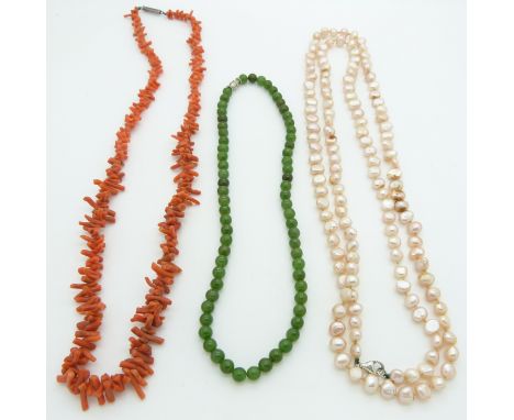 A coral necklace, a pearl necklace, and a nephrite jade necklace&nbsp;
