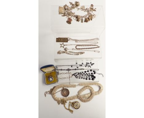 A collection of silver jewellery including charm bracelet with over 18 charms, gate bracelet, necklace, ingot and chains, Wed
