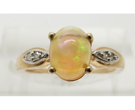 A 9ct gold ring set with an opal cabochon and diamonds, 1.8g, size J