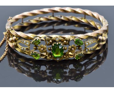 Edwardian 9ct rose gold rope twist bangle set with garnet doublets and seed pearls amongst floral decoration, 12.1g