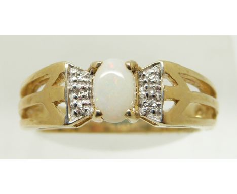 A 9ct gold ring set with an oval opal cabochon and diamonds, 2.9g, size N