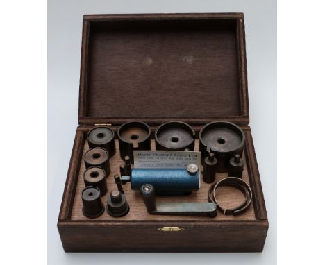 A clock spring winding tool set in wooden case&nbsp;