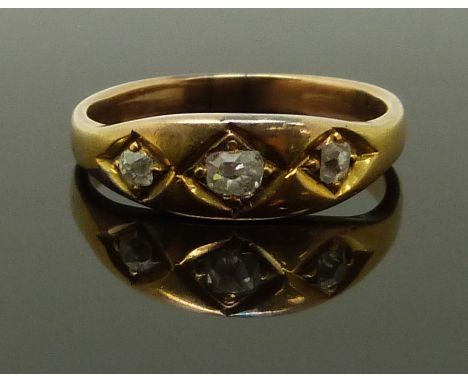 A late Victorian yellow metal ring set with three old cut diamonds, size K, 3.20g&nbsp;