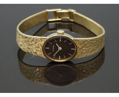 Eterna 14ct gold ladies wristwatch with white hands and baton markers, chocolate dial and signed movement, on integral 14ct g