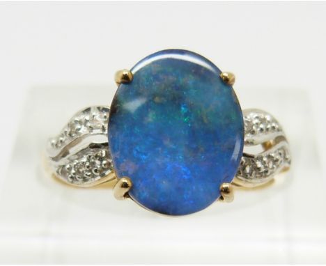 A 9ct gold ring set with an oval boulder opal cabochon of approximately 2.2cts and zircons, 2g, size N