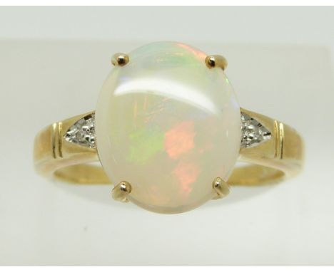 A 9ct gold ring set with an oval opal cabochon and diamonds,2.5g, size N