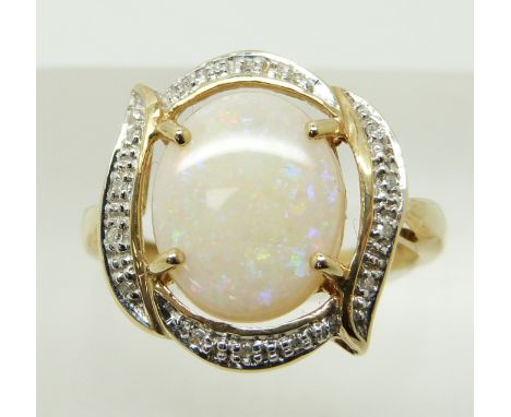 A 9ct gold ring set with a large oval opal cabochon and diamonds, 3.3g, size N