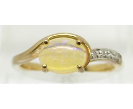 A 9ct gold ring set with an oval opal cabochon and diamonds, 2g, size N