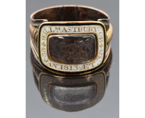 Georgian mourning ring set with plaited hair in a glass compartment with white enamel border reading "William Astbury OB 22nd