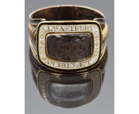 Georgian mourning ring set with plaited hair in a glass compartment with white enamel border reading "William Astbury OB 22nd