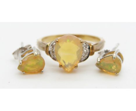 A 9ct gold ring set with a pear cut Indonesian opal and diamonds (size N) and a pair of 9ct white gold earrings set with a pe