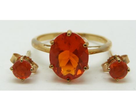 A 9ct gold ring set with an oval cut Mexican fire opal (size L/M) and a pair of earrings set with a Mexican fire opal to each