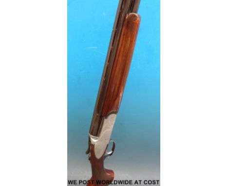 Rizzini 12 bore over and under shotgun with ornate engraving of birds among scrolling decoration to the locks, chequered semi