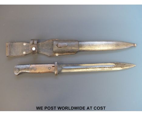 A 1944 Nazi K98 1884/98 bayonet, scabbard and frog, the blade stamped 'COF', matching numbers 8088 on blade and metal scabbar