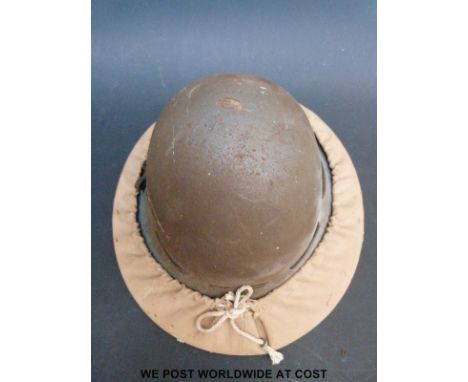 A British Civil defence helmet with canvas carrier and shoulder strap