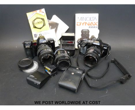 A collection of vintage cameras including Minolta, Dyrax 7000i, Dyrax 3000i, lenses and instruction manual
