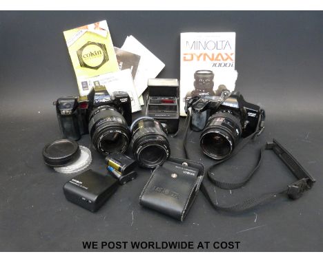 A collection of vintage cameras including Minolta, Dyrax 7000i, Dyrax 3000i, lenses and instruction manual