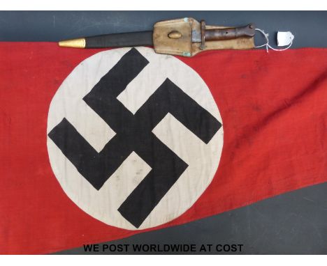 A Nazi German WWII pennant flag with swastika, by repute removed from a German tank, approximately 56 x 115cm overall togethe