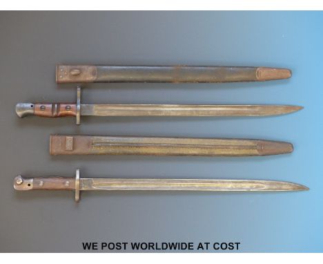 A Remington 1917 bayonet together with a Wilkinson example