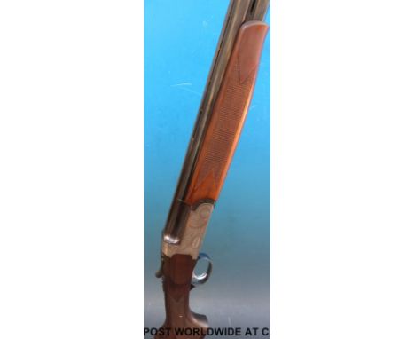 Brescia Italian 12 bore over and under shotgun with ornate floral engraving to the locks, chequered grip and forend, vented t