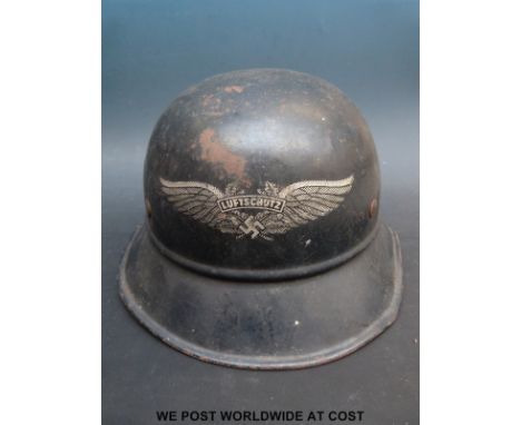 A Nazi German 'Luftschutz' helmet complete with registration number and original Kopfweite decal to interior
