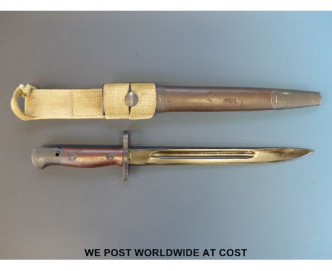 An Australian Owen sub-machine gun bayonet, in brown leather scabbard with webbing frog