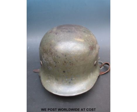 A WWII German SS helmet stamped ET66 and 3683 to inner rim