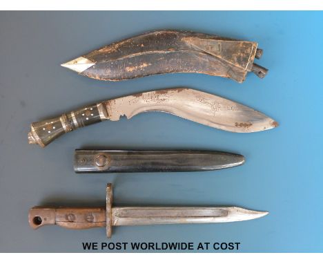 A short bayonet in scabbard and a similar sized kukri