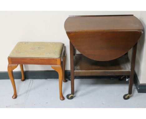A mahogany flap sided two tier trolley together with an antique mahogany tapestry upholstered footstool 