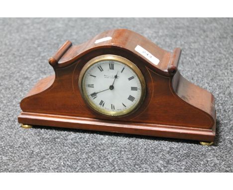An antique inlaid mahogany Swiss made mantel clock with enamel dial retailed by Mason and Son of Middlesborough on brass feet