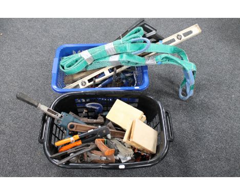 Two baskets of hand tools, spirit levels, straps etc 