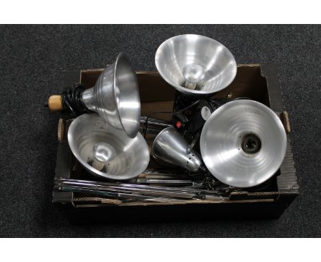 A box of photographic lighting and tripods