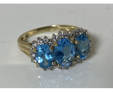 A 9ct gold blue topaz ring, size O CONDITION REPORT: 3.0g. Central stone 5.98mm by 7.96mm. Two others 4.65mm by 7mm. The ston