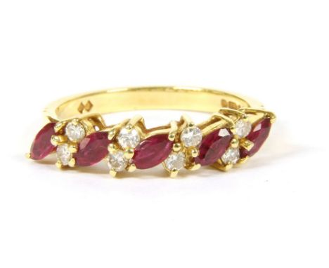 A 18ct gold ruby and diamond half hoop ring, f ive marquise cut rubies, claw set diagonally between pairs of Swiss cut diamon
