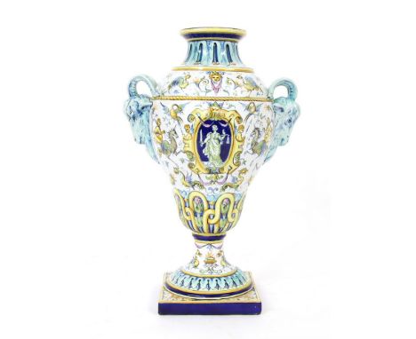 An Italian majolica twin handled urn vase, in the Cantagalli/ Ginori style, the circular neck over an oviform body with goat 