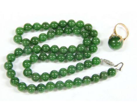 A single row of uniformed hardstone bead necklace, strung plain to a silver clasp, and a gold single stone bead ring, claw se