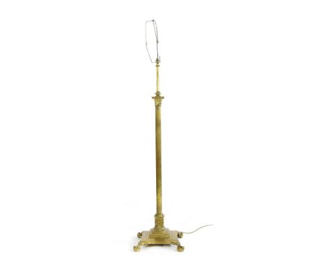 A corinthian column gilt brass adjustable standard lamp , on claw and ball feet, 125cm tall