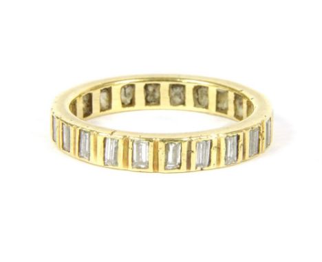 A flat section diamond full eternity ring . Baguette cut diamonds, rub set to plain polished guards. Tested as approximately 