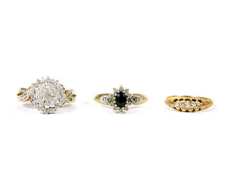 An 18ct gold five stone diamond ring, 1.79g, a gold diamond cluster ring marked 9k, 3.87g, and a 9ct gold sapphire and diamon