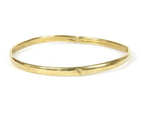 A 9ct gold hollow bangle , tension clasp, hallmarked 9ct gold, damaged , 5.79g