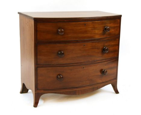 A mahogany bow front chest, 19th century, of three graduated long drawers, each with knob handles and on outswept bracket fee