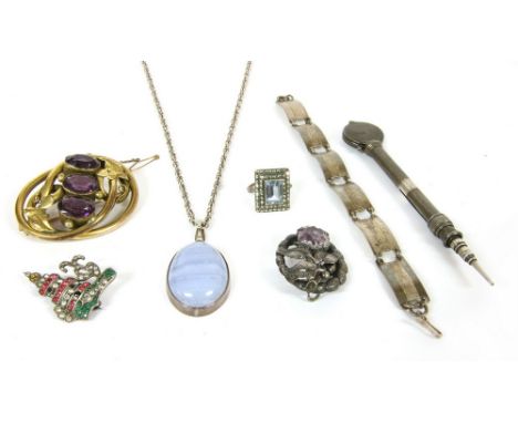 A rolled gold three stone amethyst scroll brooch, a silver step cut synthetic spinel and marcasite ring, a silver banded agat