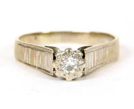 An 18ct white gold single stone diamond ring, illusion set with textured shoulders, 3.98g