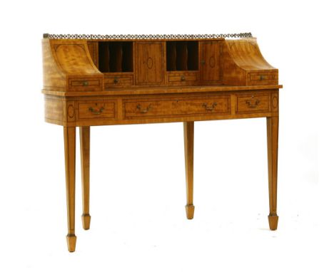 An Edwardian satinwood Carlton house desk, on square tapering legs and spode feet, 120cm wide, 55cm deep, 106cm high