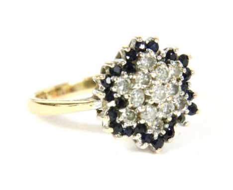 A 9ct gold diamond and sapphire cluster ring, a centre claw of brilliant cut diamonds to a border of circular cut sapphires, 