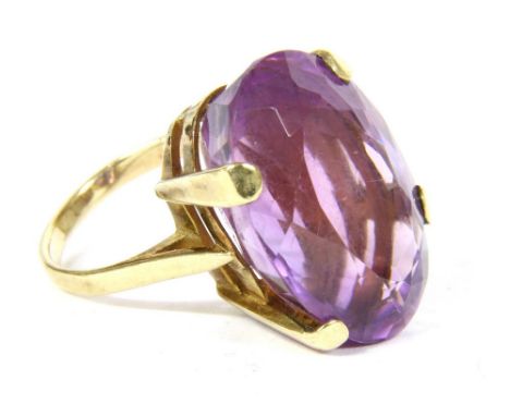A single stone amethyst ring, a mixed oval cut amethyst, claw set to an open gallery and a plain polished shank, marked 9ct, 