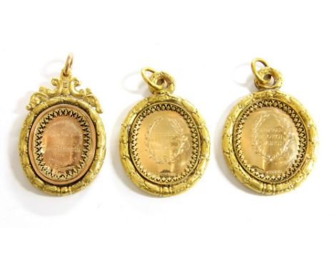 Two 15ct gold oval medallions, inscribed 'Raibearto MacDougall, mounted in gilt frames with ring suspensions, and a 9ct gold 